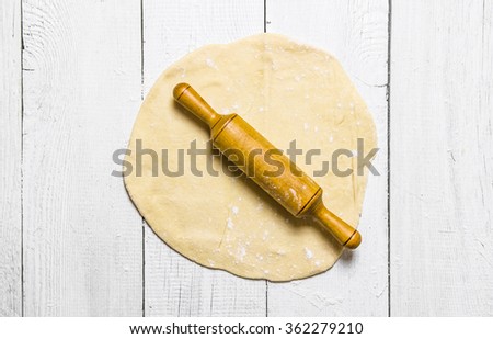 Similar – Roll out the dough with a rolling pin