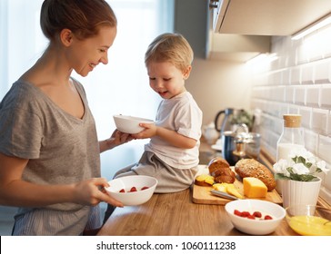 Preparation Of A Family Breakfast. Mother And Baby Son Cook Porridge In Morning
