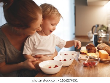 Preparation Of A Family Breakfast. Mother And Baby Son Cook Porridge In Morning
