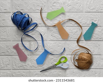 Preparation for father's day, bachelor party, corporate party.  Creating a decorative garland in business style. Ties cut out of paper, craft thread, scissors. Flat design. - Powered by Shutterstock