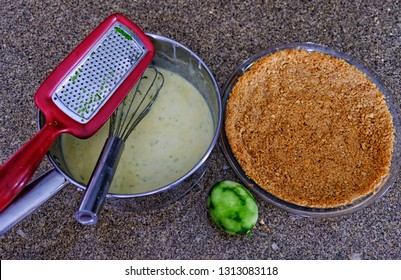 Preparation Of Filling For Key Lime Pie In Pit With Crust, Lime, Zested Shot From Above