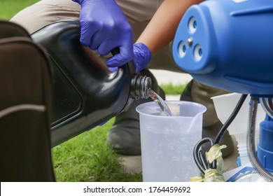 Preparation Of Fogging Disinfection Machine, Pouring Liquid Disinfectant To Be Used As Spray Disinfection. Cleaning And Disinfecting: Key Weapons In The Fight Against Contagious Diseases. 
