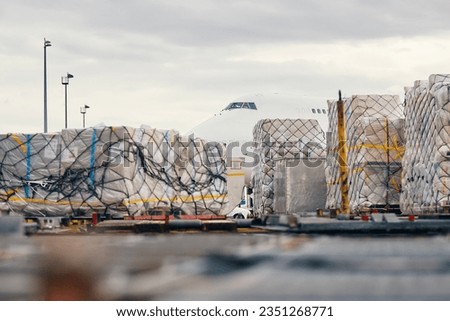 Preparation freight airplane before flight. Loading of cargo containers to plane at airport. 
