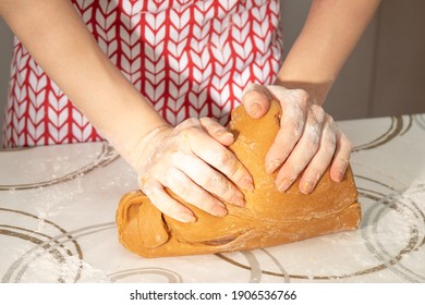 Preparation of gingerbread, Women's hands knead the dough rolled out