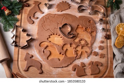 Preparation of homemade gingerbread Christmas cookies - cutting out shapes from dough - Powered by Shutterstock