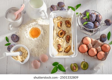 Preparation for homemade and tasty plum cake with fruits and crumble. Ingredients for homemade plum cake. - Powered by Shutterstock