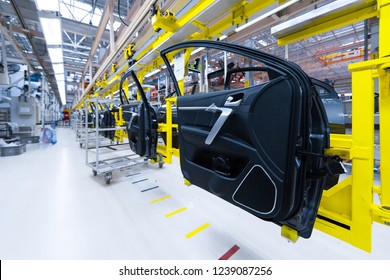 Preparation For Installation Of Body Part In Car Factory. Door From Car On Production Line