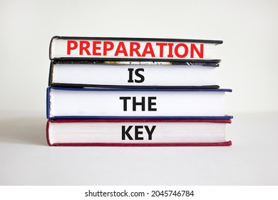 Preparation is the key symbol. Books with words 'Preparation is the key'. Businessman hand. Beautiful white background, copy space. Business and preparation is the key concept.