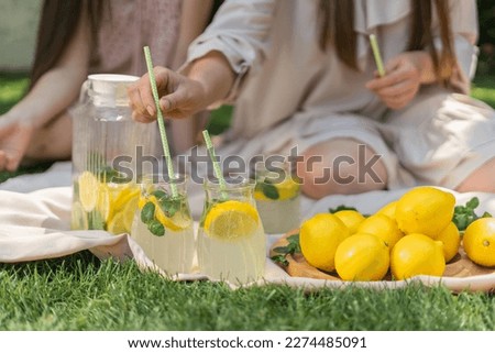 Preparation of the lemonade drink. Lemonade in the jug and lemons with mint