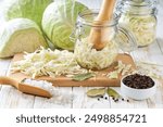 preparation for making sauerkraut or fermented white cabbage: white cabbage, caraway seeds, black pepper, salt, bay leaves. Food fermentation. Fermented preserved vegetarian food.