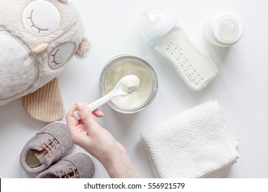 preparation of mixture baby feeding on white background top view - Shutterstock ID 556921579