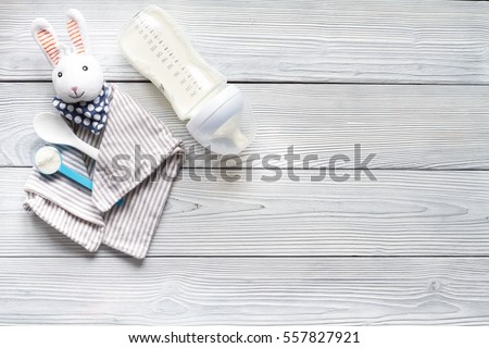 preparation of mixture baby feeding on wooden background top view