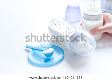 preparation of mixture baby feeding on white background