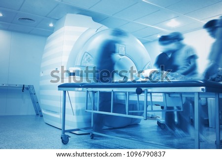 Preparation to the MRI scanning process of critically ill person in the hospital department of radiology.