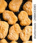 Preparation of nuggets. Fast food. Fast food - nuggets, junk food. Battered pieces of meat in a pan.