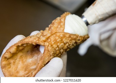 Preparation phase of the typical Sicilian cannoli inserted in the fried wafer of sweetened sheep's ricotta cheese Turin Italy October 2018