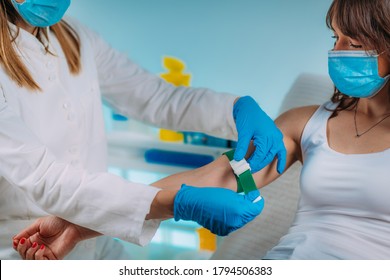 Preparation For Phlebotomy Procedure, Female Patient And Medical Nurse Wearing Protective Masks