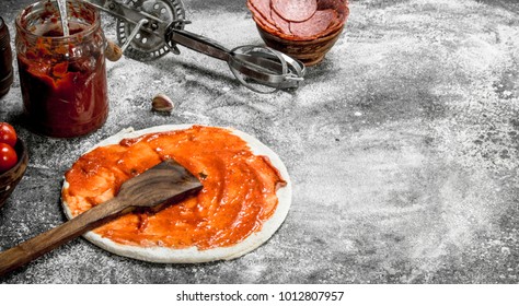 Preparation of pizza. On a rustic background. - Powered by Shutterstock