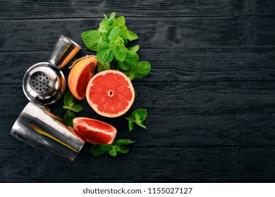 Preparation For Preparing A Cocktail Of Citrus Fruit And Mint. Lemon, Grapefruit, Lime, Orange. On A Wooden Background. Top View.