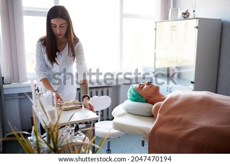 Similar – Female doctor giving medication to elderly patient