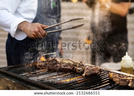 Similar – Man cooking on a barbecue