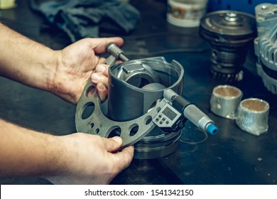 Preparation for renovation, professional repair of a diesel engine. The mechanic checks the condition of individual components, i.e. injectors, pistons, shaft, cylinders, body. Professional service.