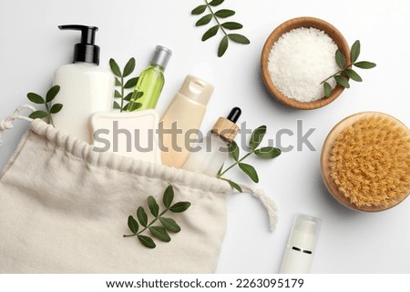 Preparation for spa. Compact toiletry bag, twigs and cosmetic products on white background, flat lay Stockfoto © 