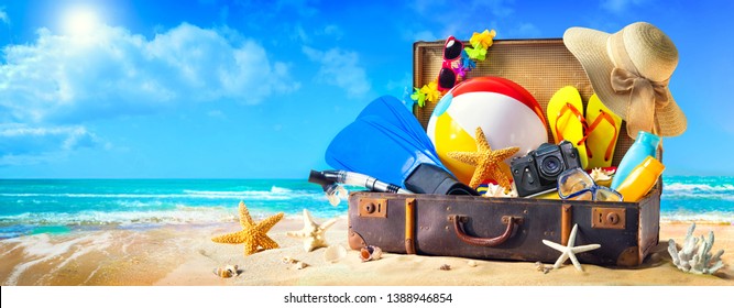 Preparation For Summer Vacation. Beach Accessories In Suitcase On Sand. Family Holidays Concept