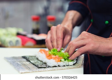 Preparation Of A Sushi Roll In Restaurant, Close Up On Chef Hands