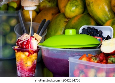 Preparation of a traditional sweet water ice with fruits called cholado in the city of Cali in Colombia