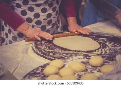 Preparation of a traditional Turkish pastries - gozleme by hands of a woman in a vintage photo