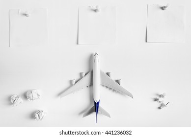 Preparation for Traveling concept and to do list, blank paper noted, paper ball, airplane, push pin, on white background with copy space.