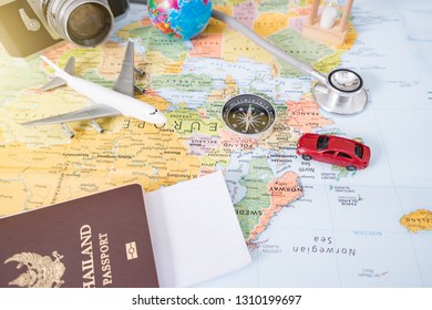 Preparation for Traveling concept, pencil, watch, money, passport, airplane, noted book, earphone, on a vintage wooden background with copy space. - Shutterstock ID 1310199697