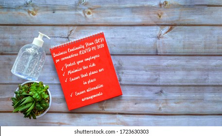 Prepare A Business Continuity Plan (BCP) For Coronavirus (COVID-19) 2020 On Red Notepad Over Wooden Background. Suitable For Company