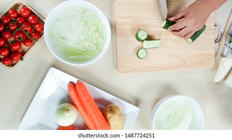 Prepare Cooking - Cut Cucumber By Female's Hand. Fresh Vegetable On Table In Kitchen (top View). Healthy Food For Family, Children, Elder, Patient, Sick Person, Diet Woman, People Who Lose Weight.