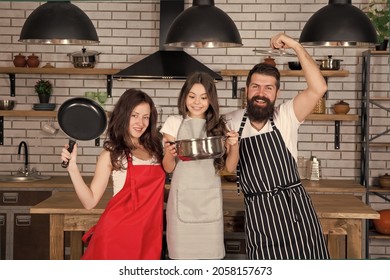 Prepare Delicious Breakfast. Lunch Time. Family Having Fun Cooking Together. Teach Kid Cooking Food. Cooking Together. Together Is More Tasty. Mom Dad And Daughter Aprons In Kitchen. Cooking Concept