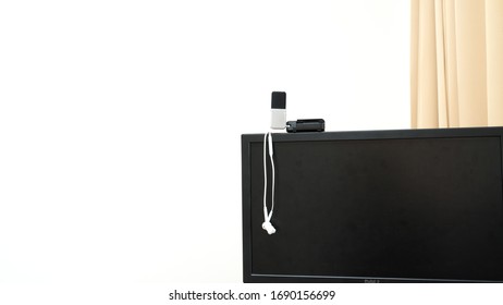 prepare earphone  and microphone on Computerscreen for work from home with white background 