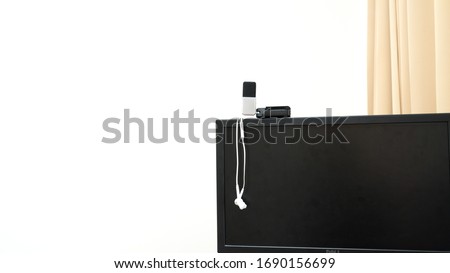 prepare earphone  and microphone on Computerscreen for work from home with white background 