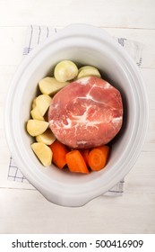 Prepare A White Slow Cooker With Ham, Carrot, Potato And Onion On Kitchen Towel