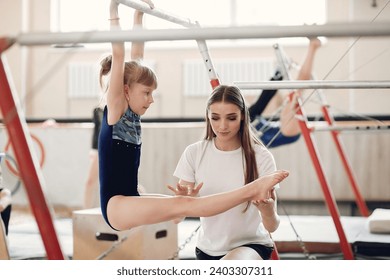 Prepare young child athlete gymnast on balance beam - Powered by Shutterstock