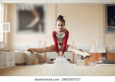 Prepare young child athlete gymnast on balance beam - Powered by Shutterstock