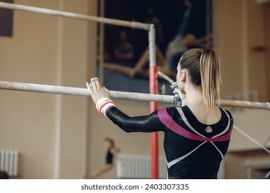 Prepare young child athlete gymnast on balance beam - Powered by Shutterstock