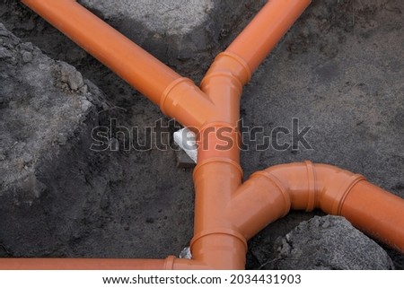 Prepared Drainage System from Plastic pipes made by plumber in the ground during the building of a modular house in Europe. Construction Engineering concept