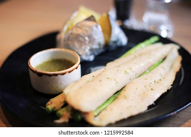 Prepared Grilled Basa Fish Fillet With Baked Potatoes And Seafood Dipping Sauce. Diet Food Menu Steak For Healthy Lifastyle.