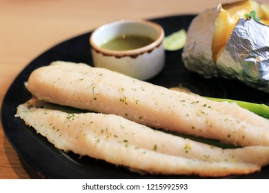 Prepared Grilled Basa Fish Fillet With Baked Potatoes And Seafood Dipping Sauce. Diet Food Menu Steak For Healthy Lifastyle.