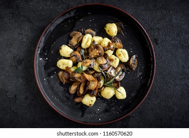 Prepared mushrooms and gnocchi dish served in the plate,selective focus 