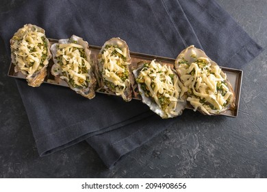 Prepared Oysters With Herb Crust And Cheese Ready For Baking In The Oven, Dark Gray Slate Background, Copy Space, High Angle View From Above, Selected Focus