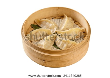 Prepared stuffed dim sum served in steamer. Dimsum is a traditional Chinese food, made from meat wrapped in a dumpling skin. Dim-sam chinese dumplings  pelmeni.