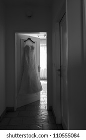 A Prepared Wedding Dress Hanging In Front Of The Dressing Room