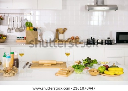 Prepared wholewheat bread, ham, eggs, green lettuce vegatable to make sandwich and salad for morning eat in kitchen. Healthy eating.